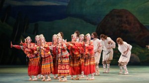 dancers in traditional costumes huddle during a performance of Igor Stravinsky's Rite of Spring as a ballet